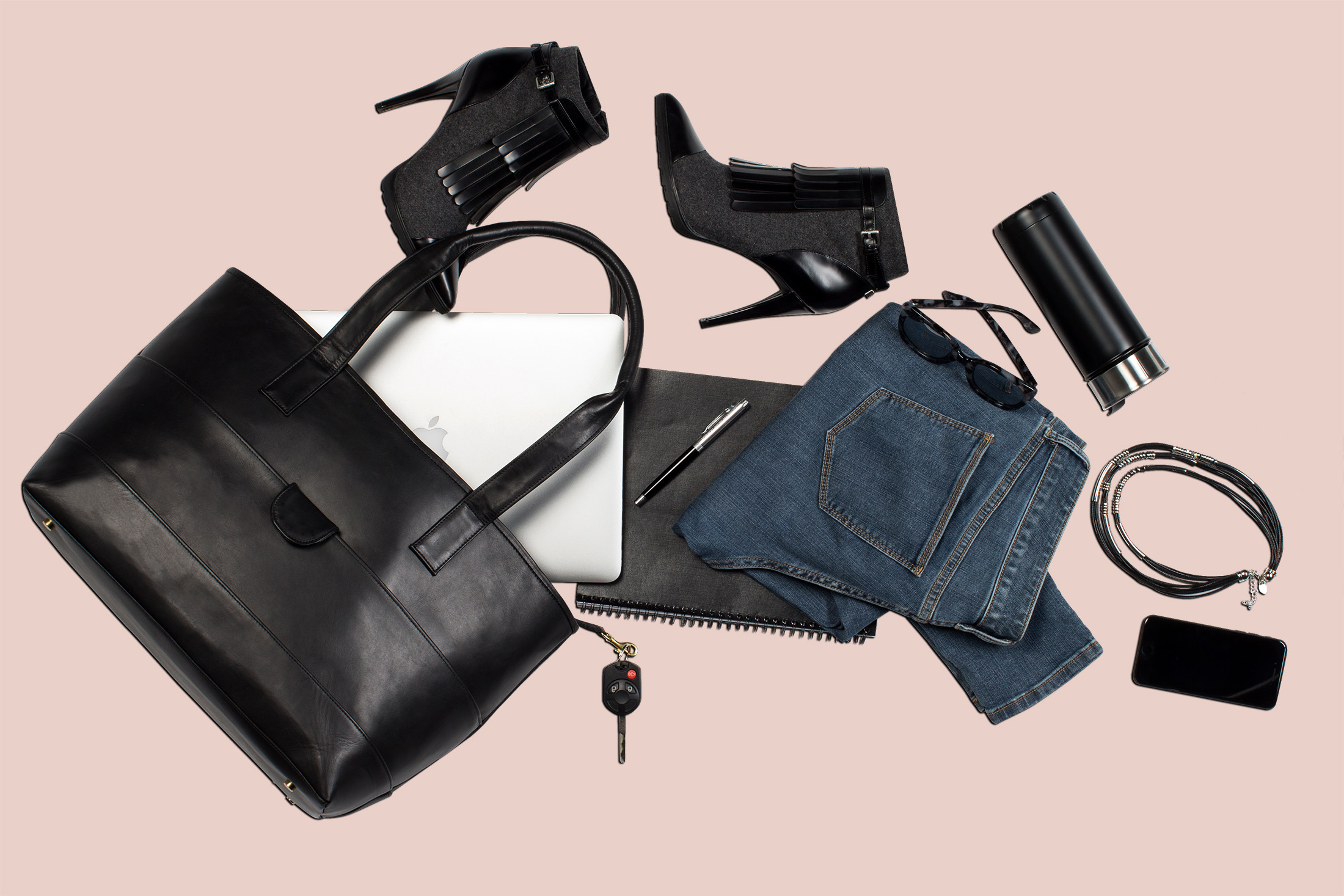 Flat lay photography for Bagwell handbags. Black tote with contents spilling onto table