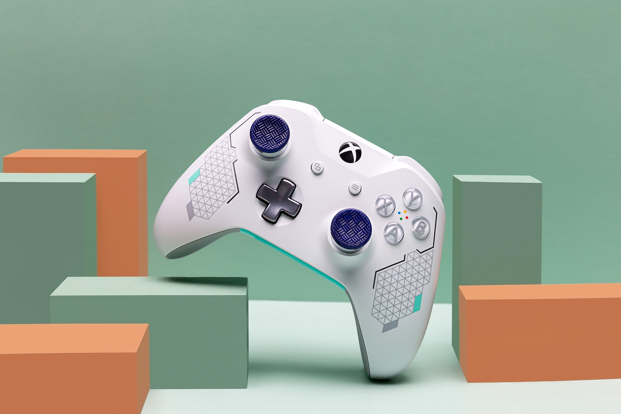 Styled scene of a white Xbox controller with purple Kontrol Freek thumbsticks.